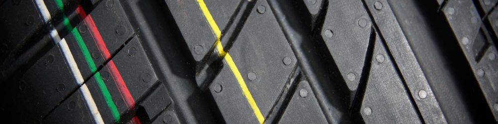 Studio shot of a set of summer car tires on black background close up. Contrasty lighting